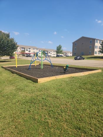 a playground with a fire hydrant in the dirt